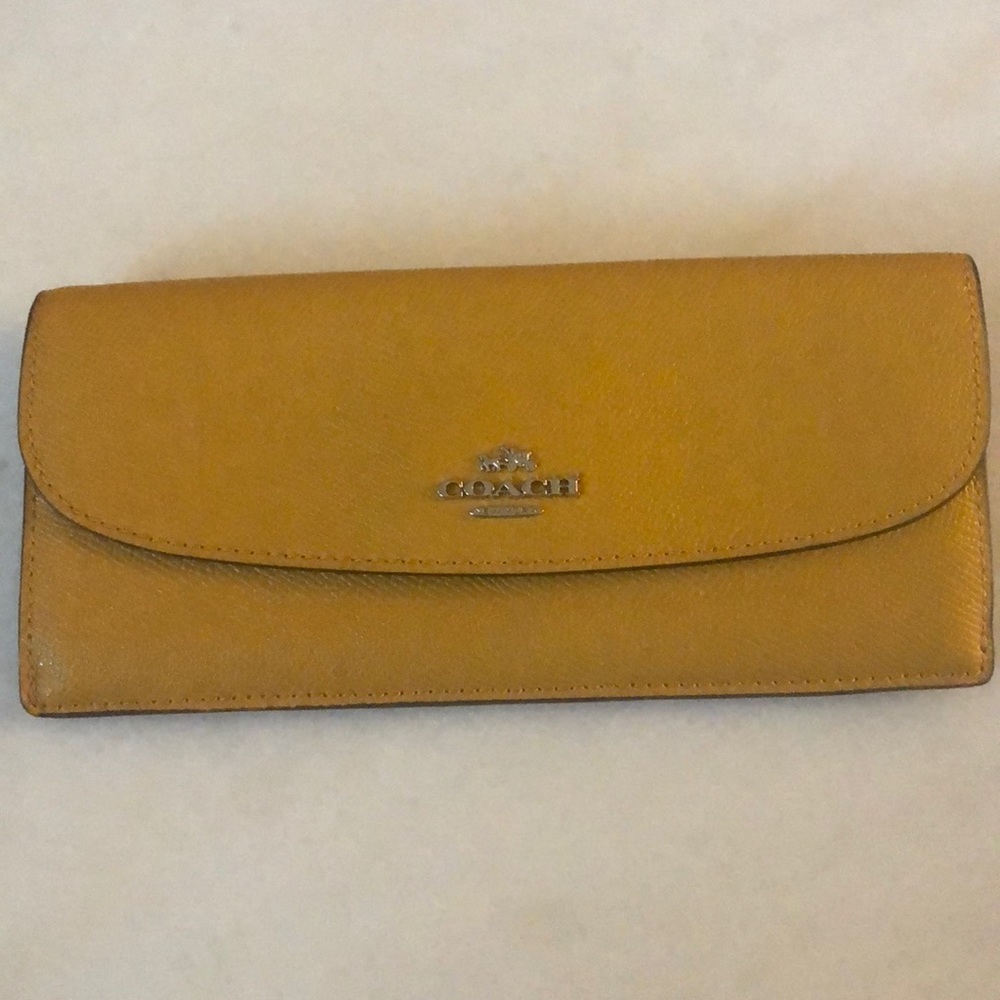 Leather Coach brand wallet mustard yellow color